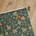 Après-Ski Goldens Wrapping Paper — unrolled on the table with scissors, twine and a gift tag