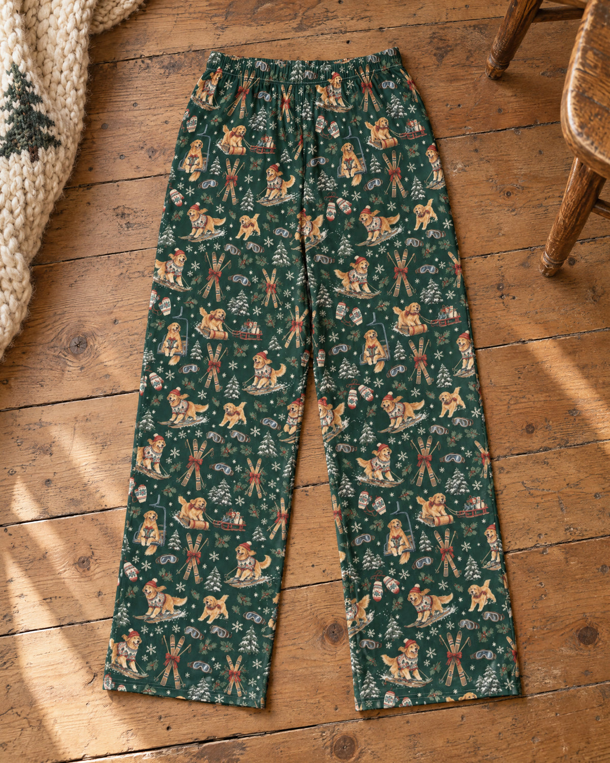 Après-Ski Goldens Wide-Leg Pajama Pants laid flat on wood with both full-length legs and matching ankle hems visible