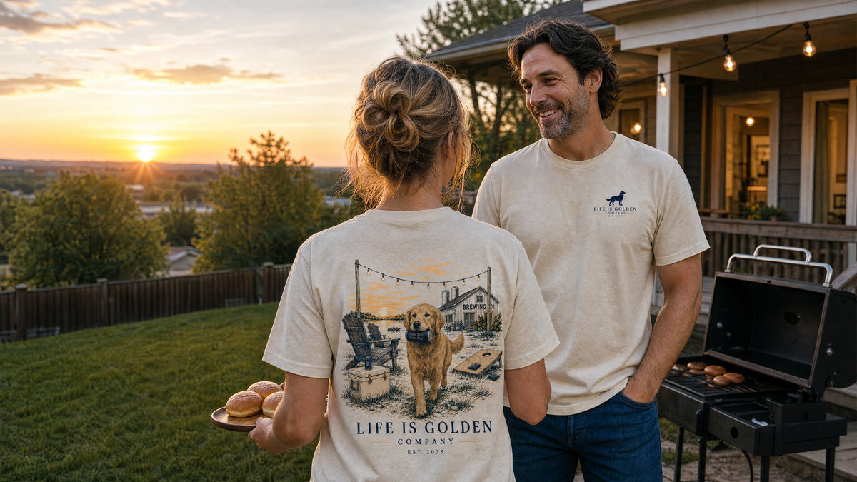 a suburban backyard at dusk, she carries burger buns toward the grill while her golden retriever pads beside her in warm porch light