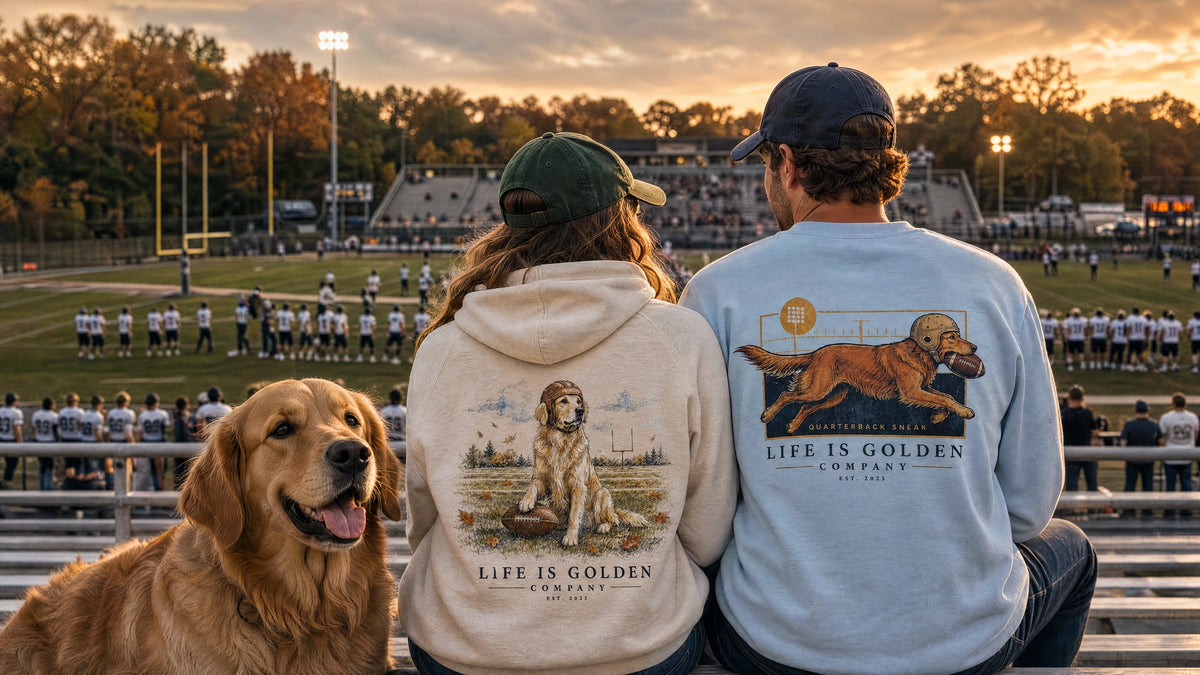 Two fans and a Golden Retriever in football bleachers, wearing the Friday Night Lights hoodie and Goal Line sweatshirt.