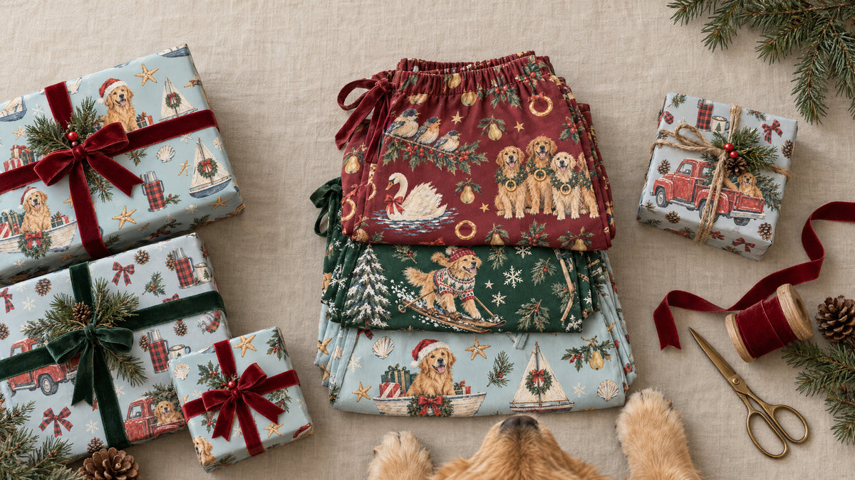 Folded golden retriever Christmas pajamas beside presents wrapped in the matching paper