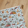 Tree Farm Christmas Wrapping Paper — unrolled on the table with scissors, twine and a gift tag