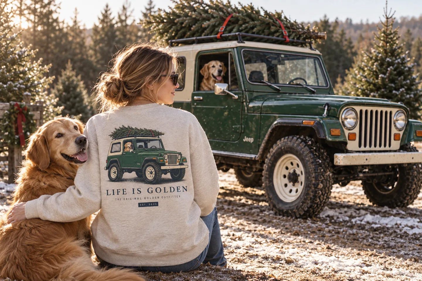 Illustrative scene of a woman wearing the Christmas car sweatshirt beside a golden retriever and a matching green Jeep